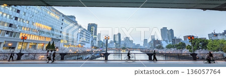Osaka: Twilight and cherry blossoms at Tenmabashi Bridge, buildings along the Okawa River, and spring scenery Osaka: Twilight and cherry blossoms at Tenmabashi Bridge, buildings along the Okawa River, and spring scenery 136057764