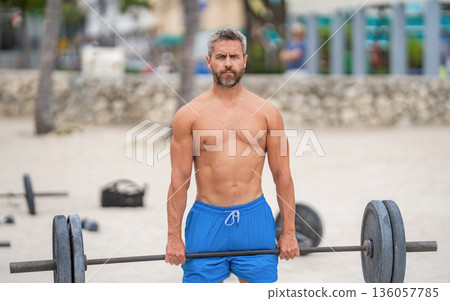 Gym workout. Sport athlete man with barbell. Healthy lifestyle barbell training. Mature man exercising with barbell outdoor. Man athlete lifting barbell. Muscular man do sport exercise. Six packs 136057785
