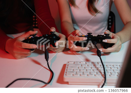 Two women are playing a video game Two women are playing a video game 136057966