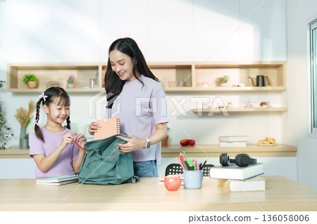 Back to School. Mother and daughter packing for school together. 136058006