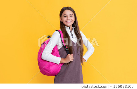 happy child with school bag on yellow background 136058103