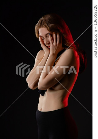 Elegant dance of a beautiful woman in soft light 136058226