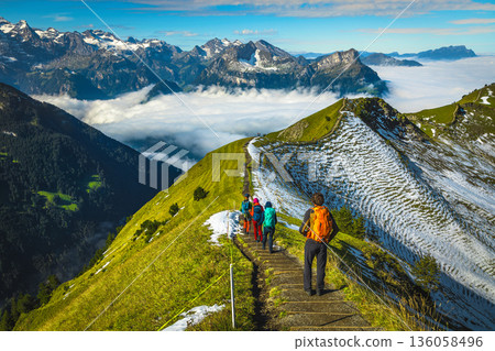 Hiker group on the famous Stoos mountain ridge in Switzerland Hiker group on the famous Stoos mountain ridge in Switzerland 136058496