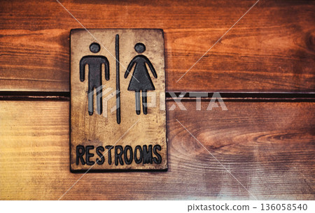 A restroom bathroom sign with traditional male and female symbols A restroom bathroom sign with traditional male and female symbols 136058540