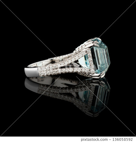 Beautiful white gold ring with diamonds and aquamarine on a black background Beautiful white gold ring with diamonds and aquamarine on a black background 136058592
