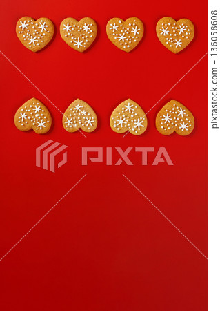 beautiful hand-baked cookies in the shape of a heart on a red background 136058608