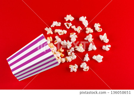 box with popcorn striped in different colors on a red background box with popcorn striped in different colors on a red background 136058651