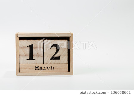 Wooden calendar March 12 on a white background Wooden calendar March 12 on a white background 136058661