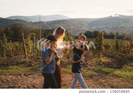 Mother Walking with Her Three Children in Vineyard 136058685