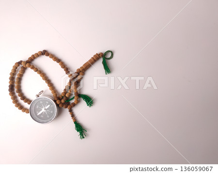 Compass paired with a set of prayer beads tasbih. Compass paired with a set of prayer beads tasbih. 136059067