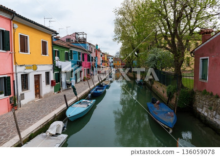 Colorful houses along canal with boats in Burano island, Venice Italy 136059078