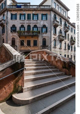 Stone bridge stairs and old Venetian building facade, Venice Italy Stone bridge stairs and old Venetian building facade, Venice Italy 136059088