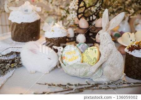 Easter still life with white bunny, decorated cakes and egg cookies 136059302