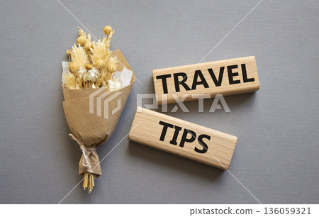 Travel tips symbol. Wooden blocks with words Travel tips. Beautiful grey background. Business and Travel tips concept. Copy space. 136059321