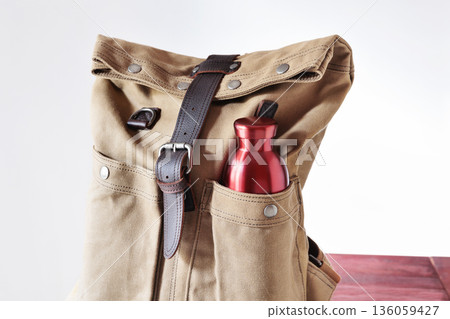 Backpack and  red waterbottle 136059427
