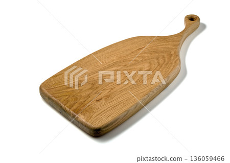 Wooden cutting board with a curly handle isolated on white background. 136059466
