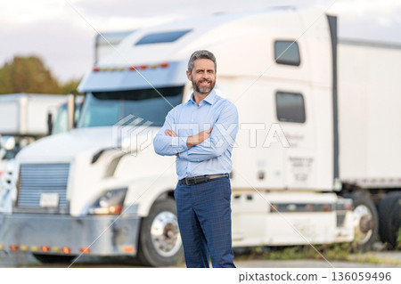 Hispanic driver in front of truck. Trucking owner. Truck driver. Man trucker driver near lorry truck. Transportation vehicle. Semi trucks vehicle. Hispanic man trucker. Businessman truck owner Hispanic driver in front of truck. Trucking owner. Truck driver. Man trucker driver near lorry truck. Transportation vehicle. Semi trucks vehicle. Hispanic man trucker. Businessman truck owner 136059496