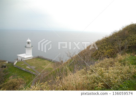 White lighthouse on a cliff and seascape White lighthouse on a cliff and seascape 136059574