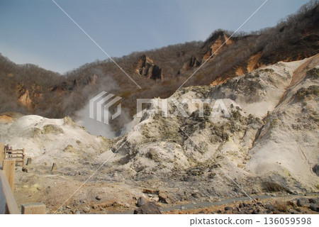 A rugged landscape of a hot spring resort. Hot springs and steam. A rugged landscape of a hot spring resort. Hot springs and steam. 136059598