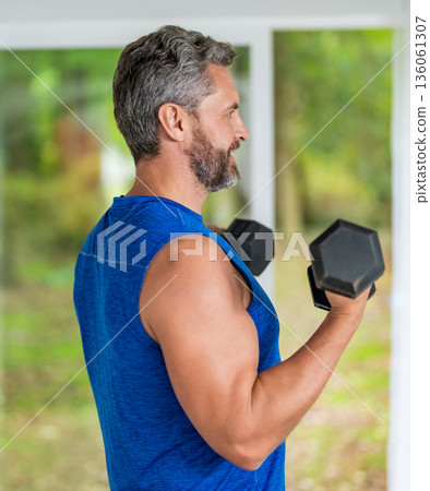 Sport athlete man with dumbbell. Healthy lifestyle. Biceps muscle. Strong triceps. Man exercising with dumbbell. Man athlete lifting dumbbell. Strong man do sport exercise. Gym workout shoulder press Sport athlete man with dumbbell. Healthy lifestyle. Biceps muscle. Strong triceps. Man exercising with dumbbell. Man athlete lifting dumbbell. Strong man do sport exercise. Gym workout shoulder press 136061307
