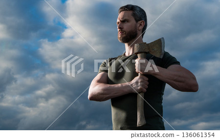 strong man with axe. woodman man hold ax. brutal man on sky background 136061354