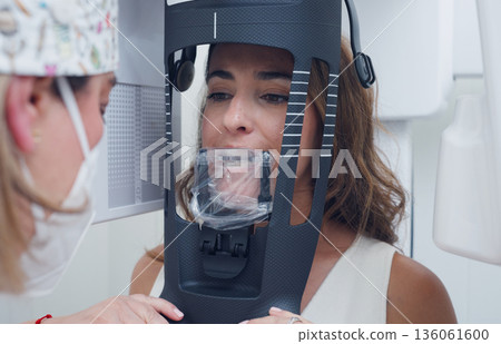 Dentist preparing patient for dental x-ray scan 136061600
