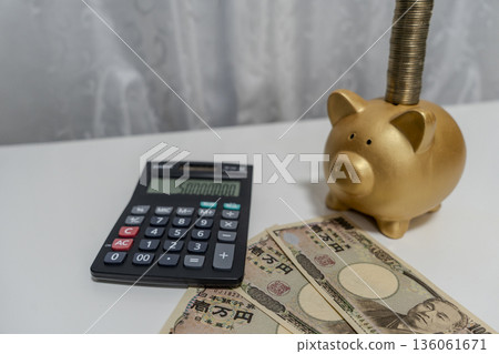 Put money in a piggy bank Put money in a piggy bank 136061671