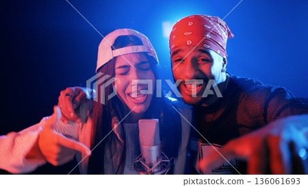 Male and female musicians recording vocal performance duo Male and female musicians recording vocal performance duo 136061693