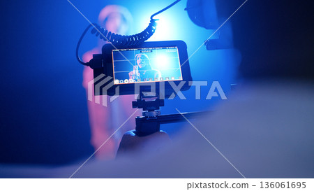Recording singer on video production set with blue light 136061695