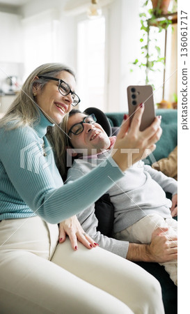 Smiling Mother and son enjoying time together taking selfie at home Smiling Mother and son enjoying time together taking selfie at home 136061717