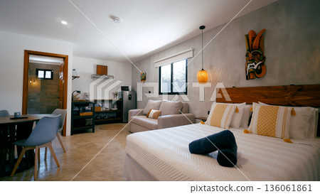 Modern studio apartment interior featuring bedroom and kitchenette 136061861