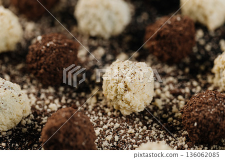 Close up of coconut and cocoa truffles on black background Close up of coconut and cocoa truffles on black background 136062085