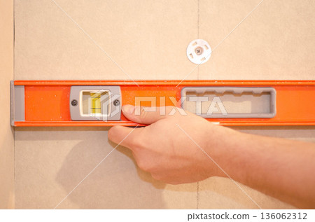 Checking Wall Alignment with Spirit Level Checking Wall Alignment with Spirit Level 136062312