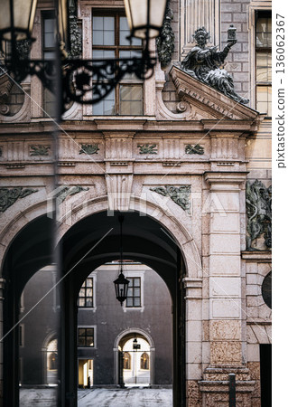 Historic Residenzstrasse Near Odeonsplatz In Munich: Ornate Baroque Facade With Sculptural Details, Arched Passageway, And Classical Urban Architecture Historic Residenzstrasse Near Odeonsplatz In Munich: Ornate Baroque Facade With Sculptural Details, Arched Passageway, And Classical Urban Architecture 136062367