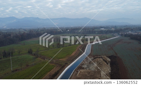 Aerial view of an irrigation canal in the rural landscape of Bedizzole, Italy Aerial view of an irrigation canal in the rural landscape of Bedizzole, Italy 136062552