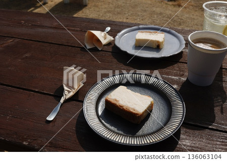 A sweet image of cheesecake for two lined up on a wooden table. A sweet image of cheesecake for two lined up on a wooden table. 136063104