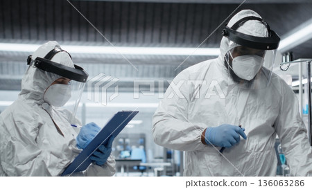 Scientific team in a virology unit monitors patient for symptoms of infection during epidemic response, conducting laboratory research on vaccines, antibiotics and antiviral therapy. Camera B. Scientific team in a virology unit monitors patient for symptoms of infection during epidemic response, conducting laboratory research on vaccines, antibiotics and antiviral therapy. Camera B. 136063286
