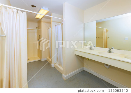 Two separate areas for showers, sinks are for personal hygiene in shared space. 136063340
