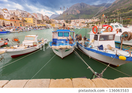 Colorful Fishing Boats Moored in Sicilian Mountain Harbor 136063583