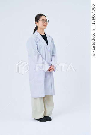 A young lady in a white suit 136064360