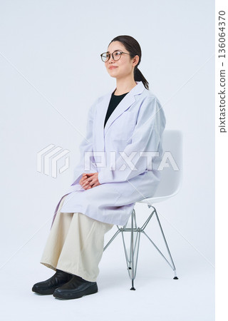 A young lady in a white suit 136064370