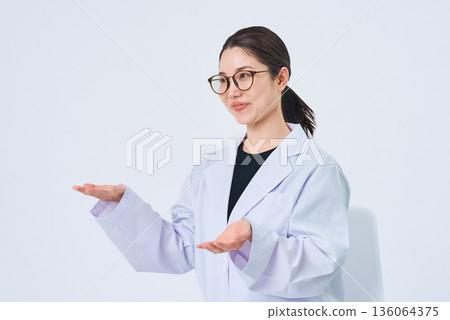 A young lady in a white suit 136064375