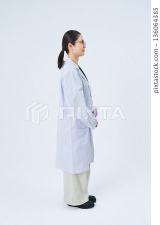 A young lady in a white suit 136064385