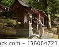 Senior woman praying at a shrine 136064721