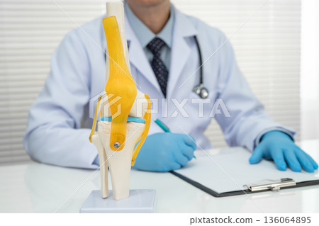 Knee osteoarthritis, Doctor showing model knee joint orthopedic. Knee osteoarthritis, Doctor showing model knee joint orthopedic. 136064895