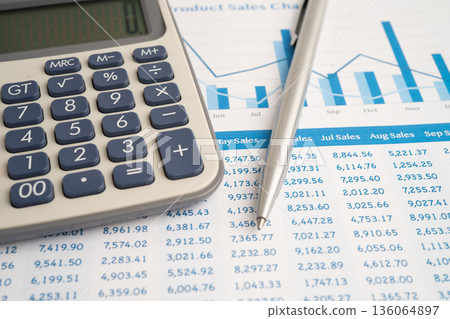 Pencil and calculator on chart or graph paper. Financial, account, statistics and business data. 136064897