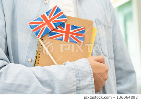 Learn English language, Asian teenage student hold book with flag in course at school. Learn English language, Asian teenage student hold book with flag in course at school. 136064898