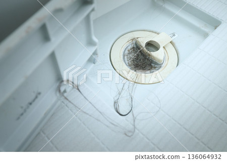 Hair stuck in the bathtub drain Hair stuck in the bathtub drain 136064932