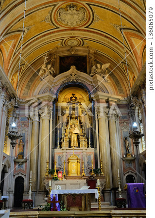Baroque church interior with gilded altar ornate nave columns arches and ceiling fresco Lisbon Portugal. High quality photo 136065079