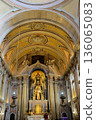 Baroque church interior with gilded altar ornate nave columns arches and ceiling fresco Lisbon Portugal. High quality photo 136065083